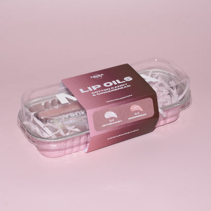 Box with two glitter Lip Oils.
One Clear glitter Lip Oil holographic and one pink LIp Oil with silver glitter.