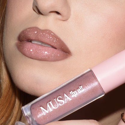 Lips with pink lip oil and silver glitter.