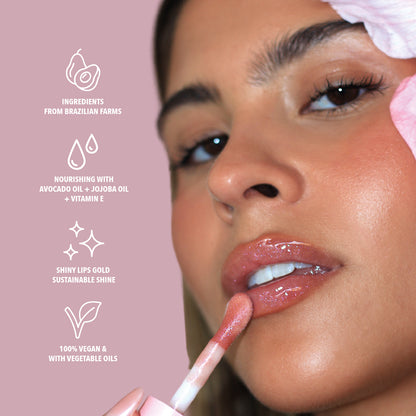 Benefits of the pink glitter lip oil with purple glitter. Made with avocado oil, vitamin E and jojoba oil. Vegan and Cruelty Free. Made with biodegradable glitter.